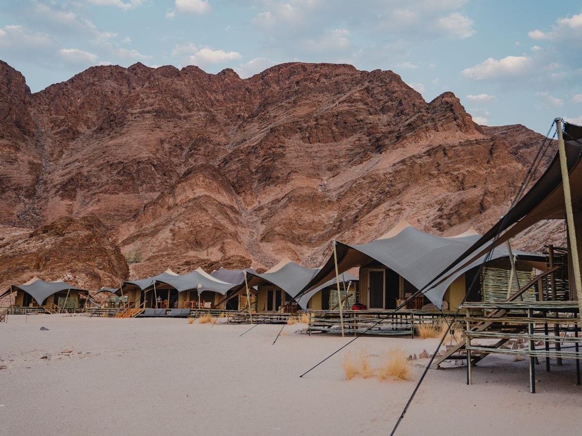 View of the tents and mountains at luxury lodge Hoanib Valley Camp in Namibia