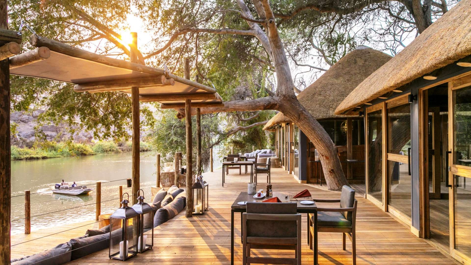Deck with al fresco dining and seating area overlooking the river