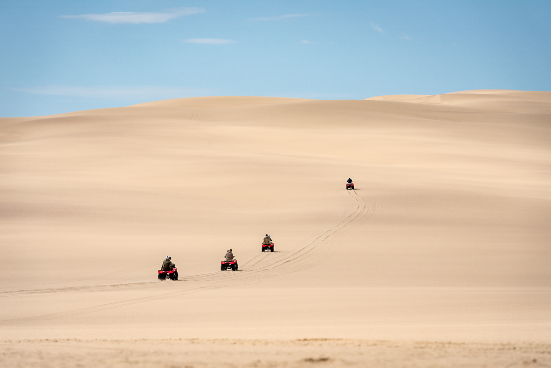 Guests of Shipwreck Lodge quad biking over dunes on the Skeleton Coast