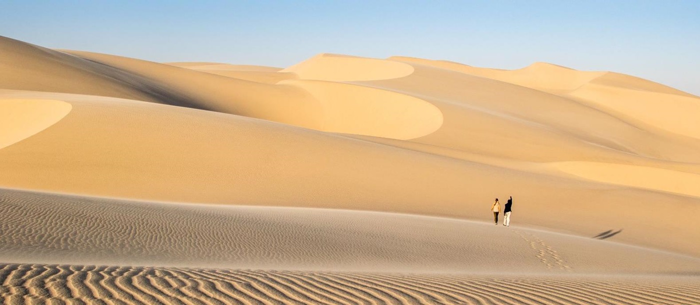 Guest exploring the desert during at stay at luxury lodge Shipwreck Lodge in the Skeleton Coast National Park, Namibia