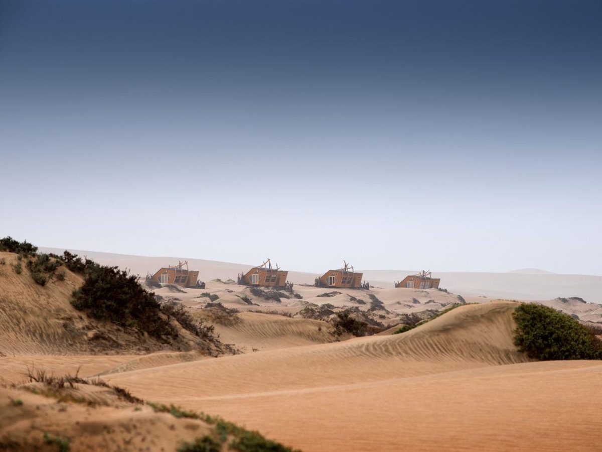 Exterior view of the cabins at luxury lodge Shipwreck Lodge in the Skeleton Coast National Park, Namibia
