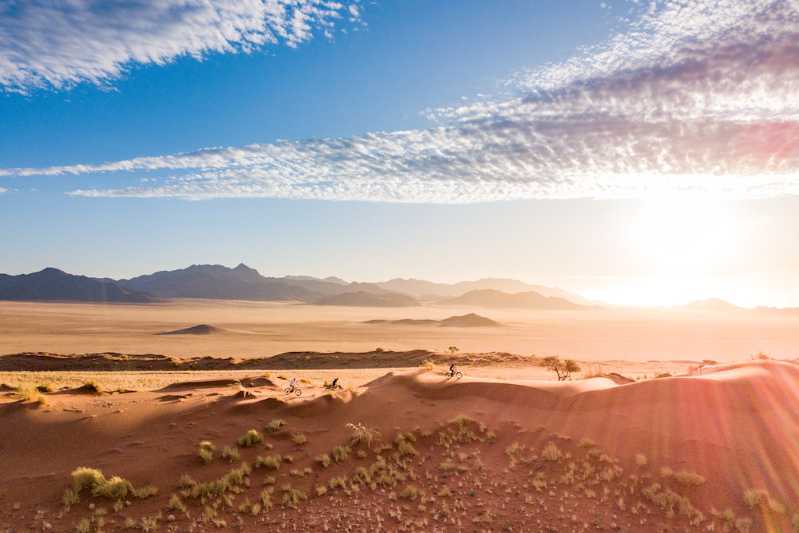Guests e-biking through the NamibRand Nature Reserve during a stay at one of the luxury lodges of Wolwedans in Namibia