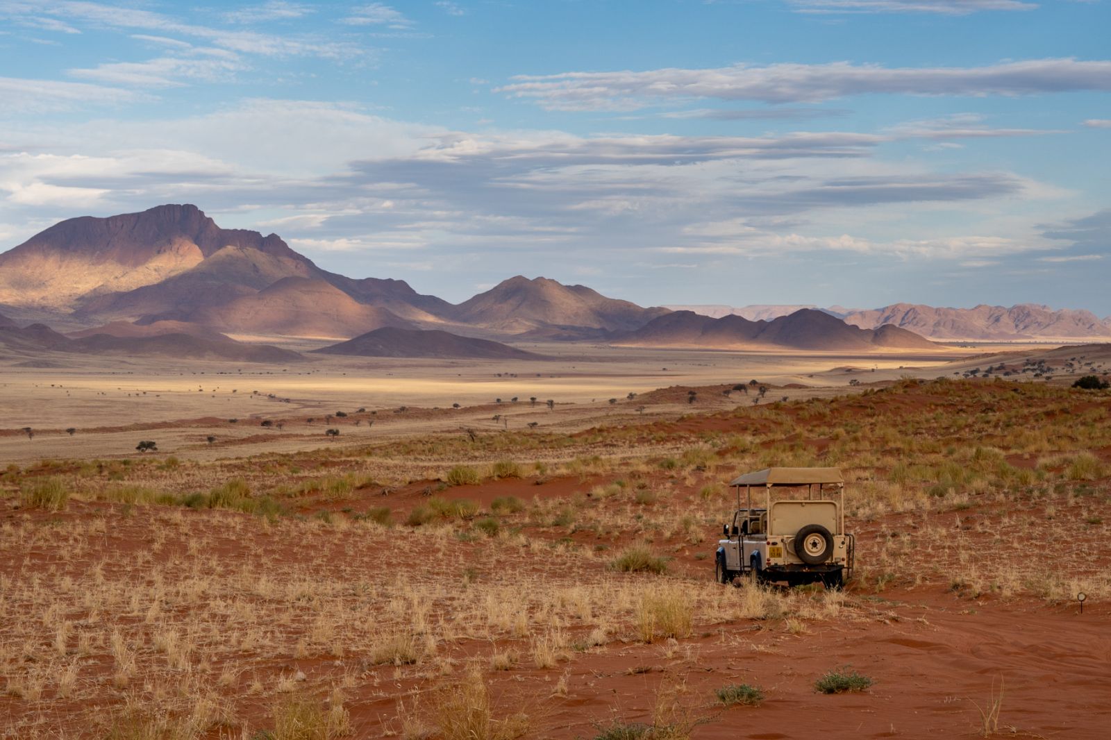 Guests on a game drive in the NamibRand Nature Reserve during a stay at one of the luxury lodges of Wolwedans in Namibia