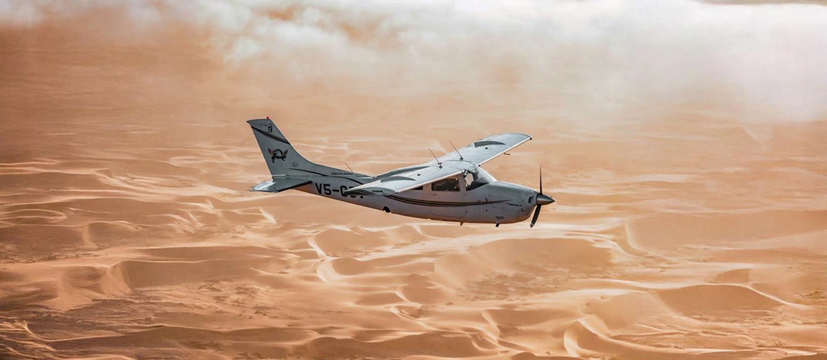 A plane flying over the Namibian desert