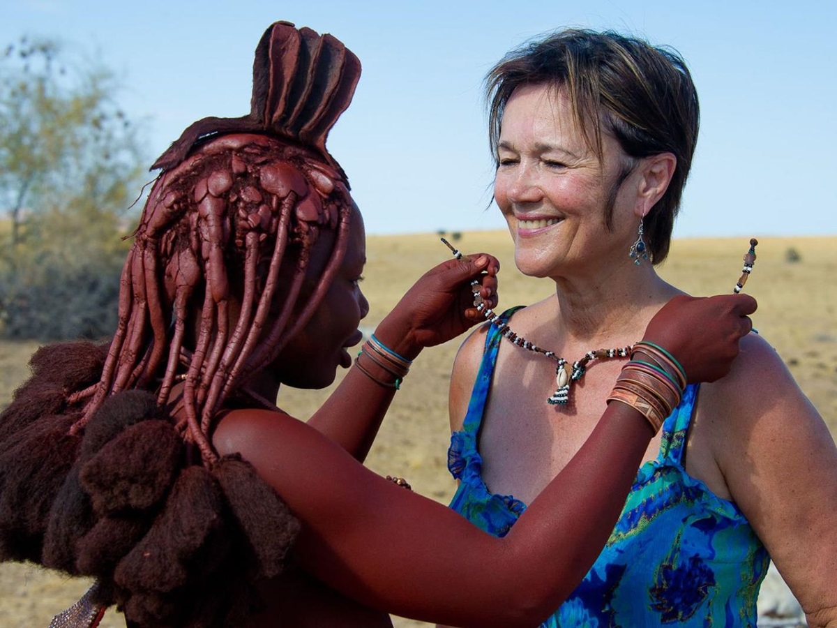 Woman purchasing a necklace from a local Himba woman in Namibia