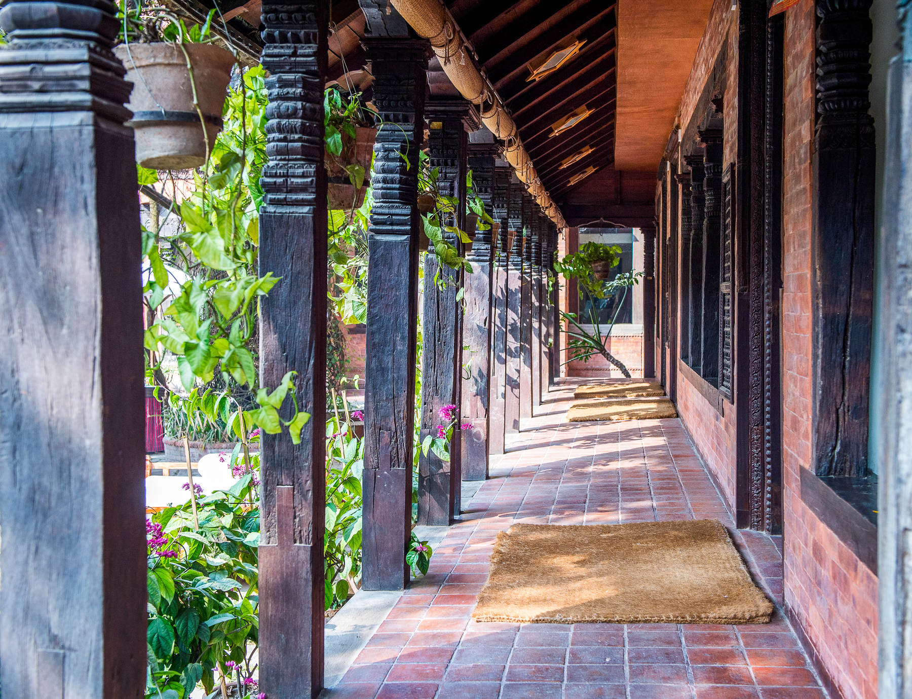 Walkway beneath striking architecture at Dwarikas Hotel in Nepal
