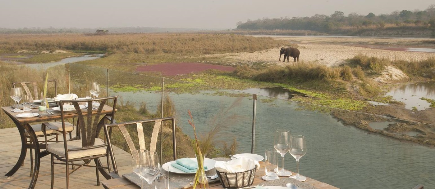 Riverside viewing deck and elephant at Meghauli Serai luxury safari camp Nepal