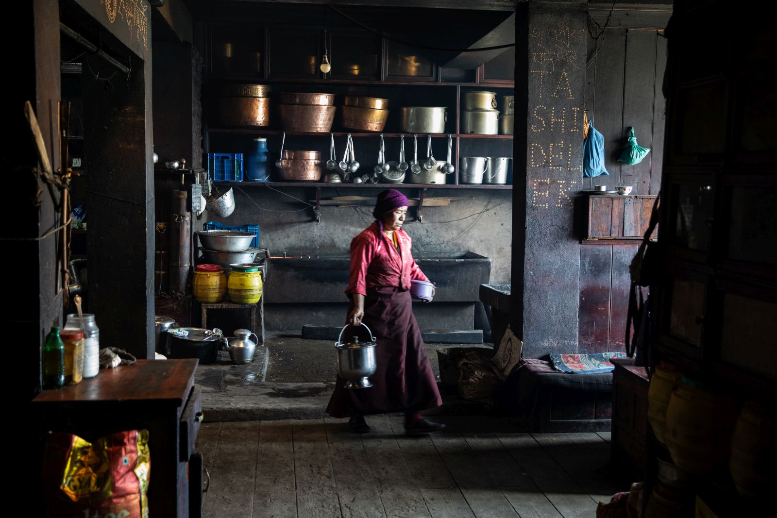 Woman walking through the kitchen in the house