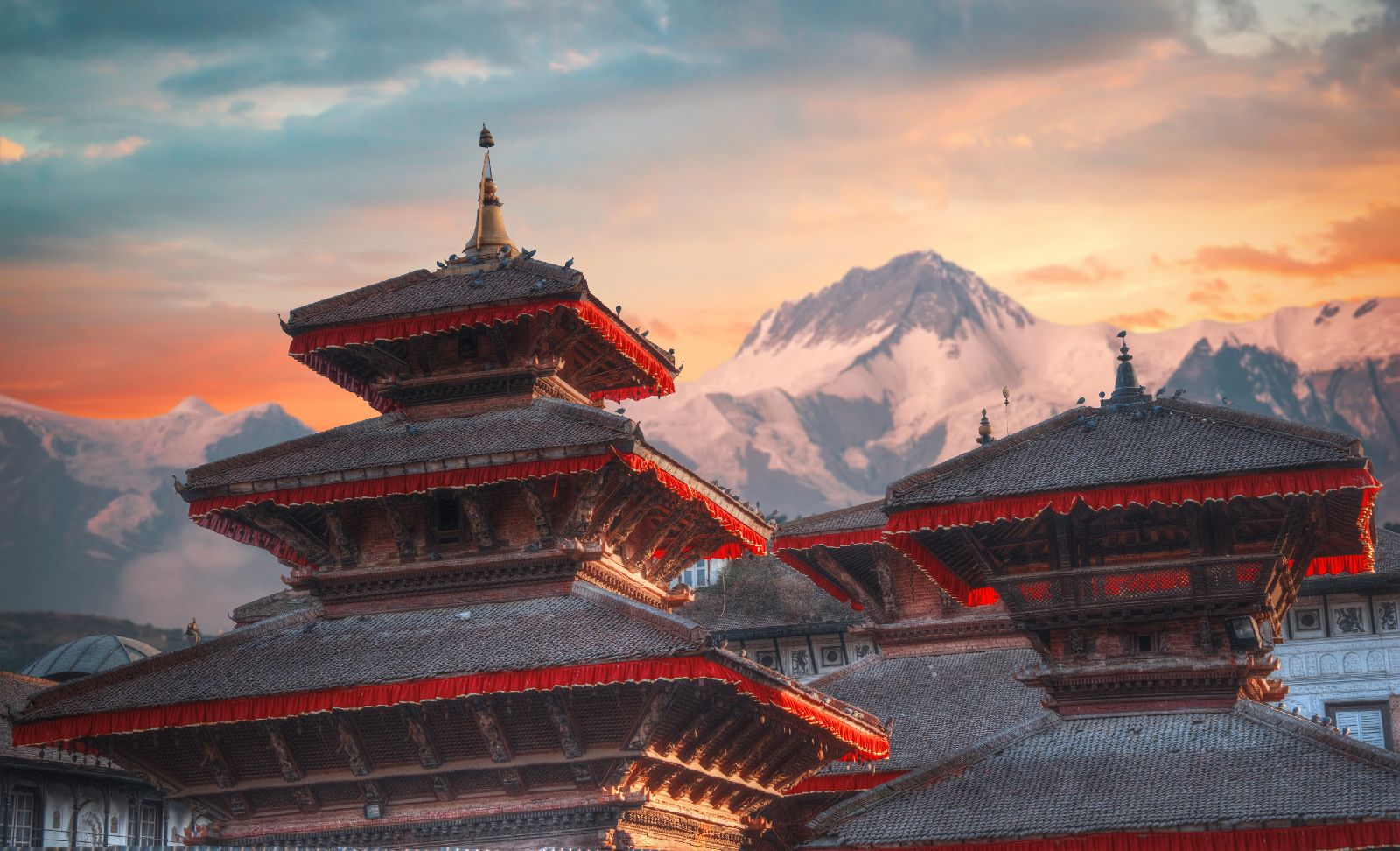 Temple and mountain backdrop in Patan, Nepal