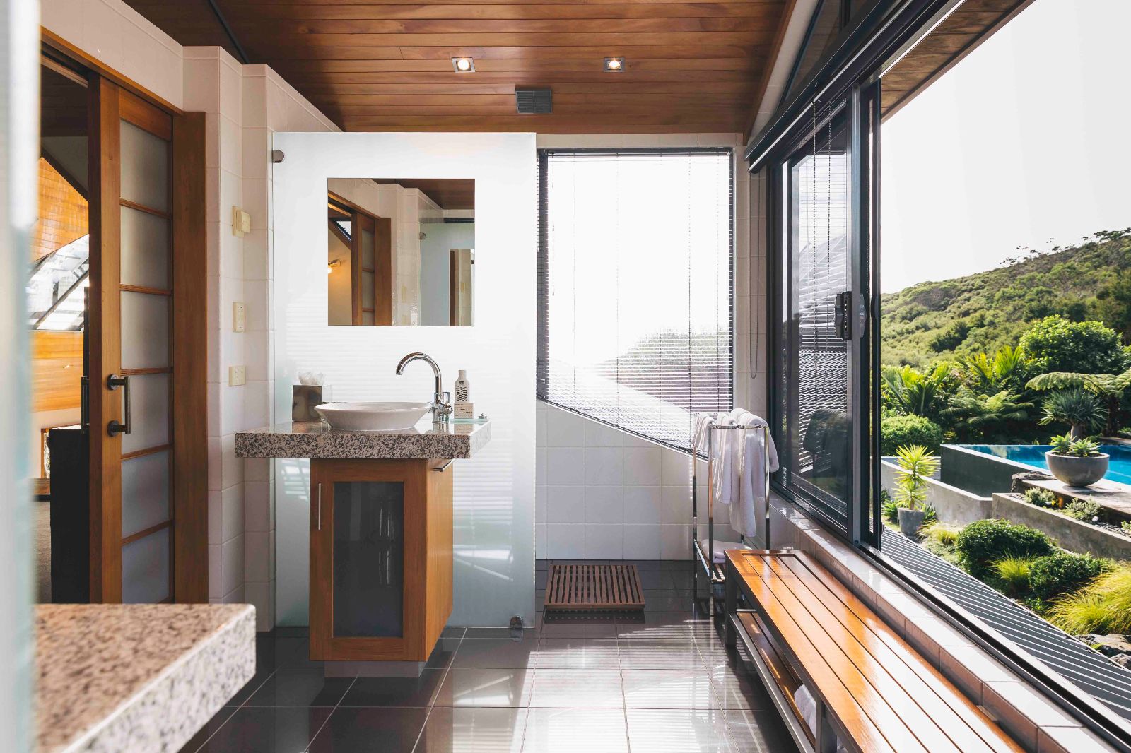 Bright bathroom space with sliding glass windows at Sacred Space Eagles Nest New Zealand