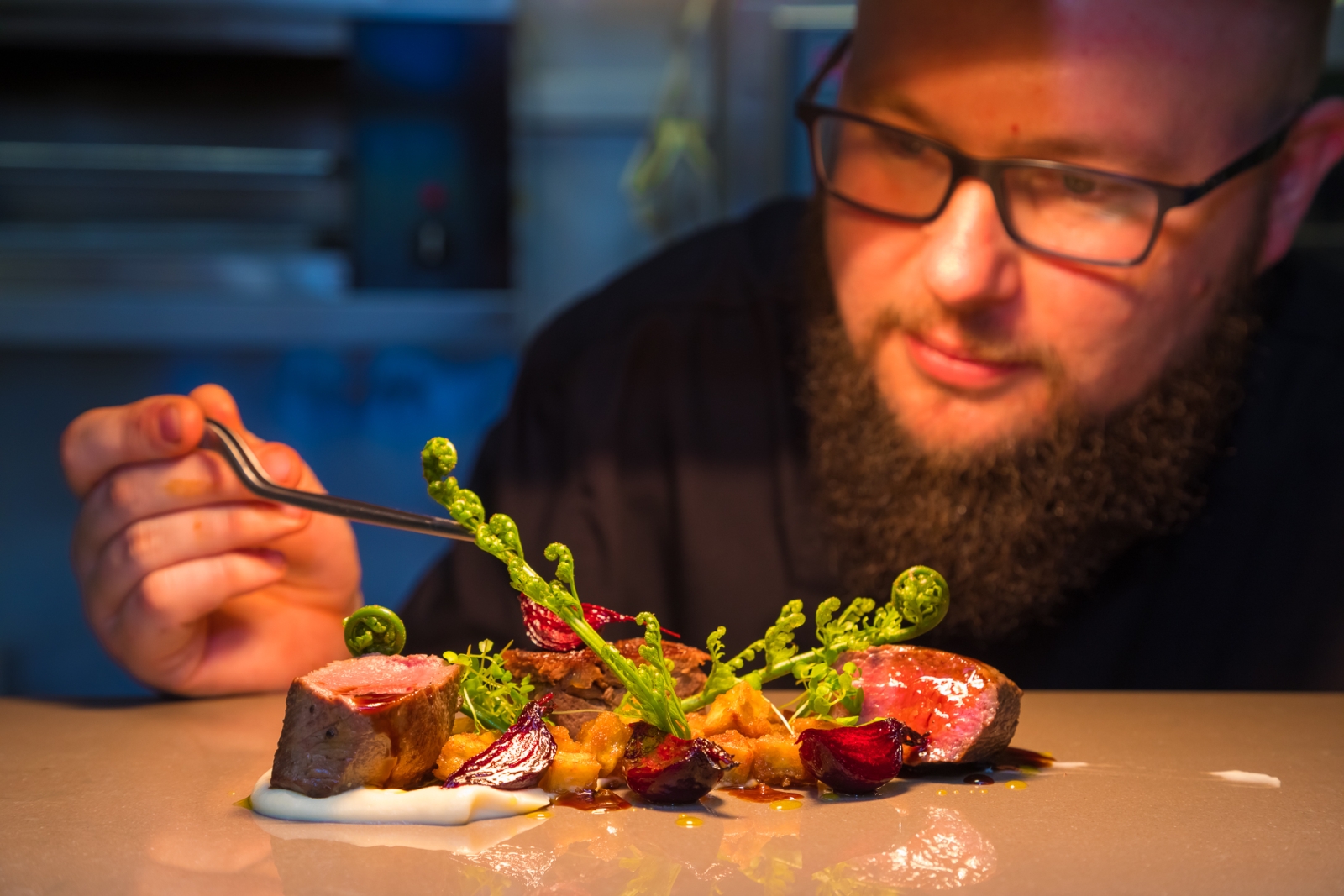 Chef with elaborate steak dish at Fiordland Lodge, New Zealand