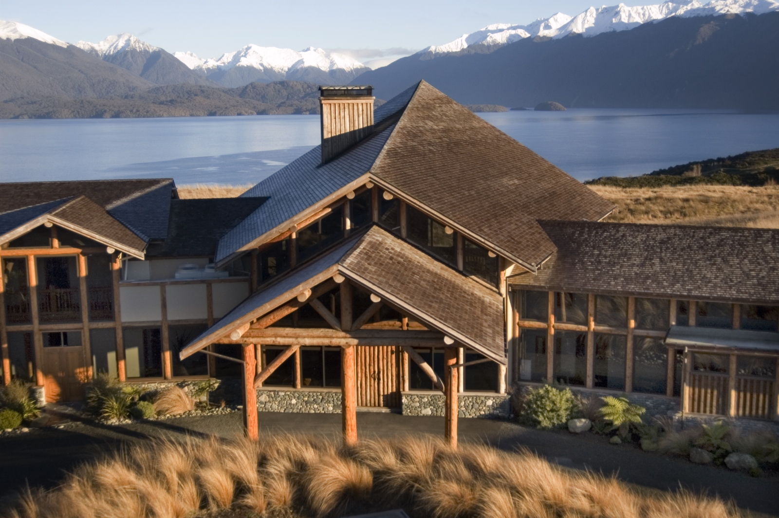 Exterior of lodge with view of fiord behind at Fiordland Lodge, New Zealand