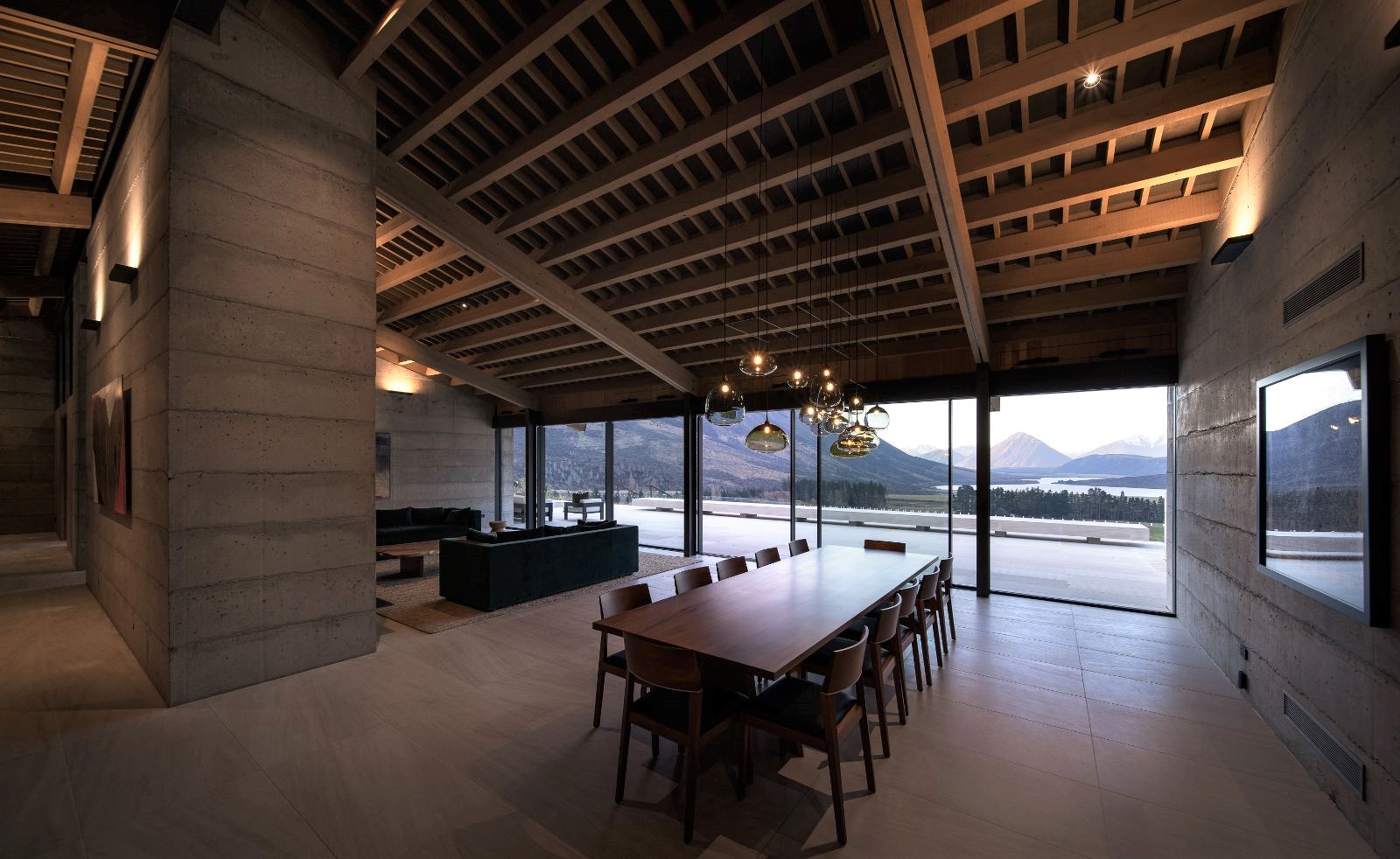 Dining room and living room with panoramic views at Flockhill lodge in New Zealand