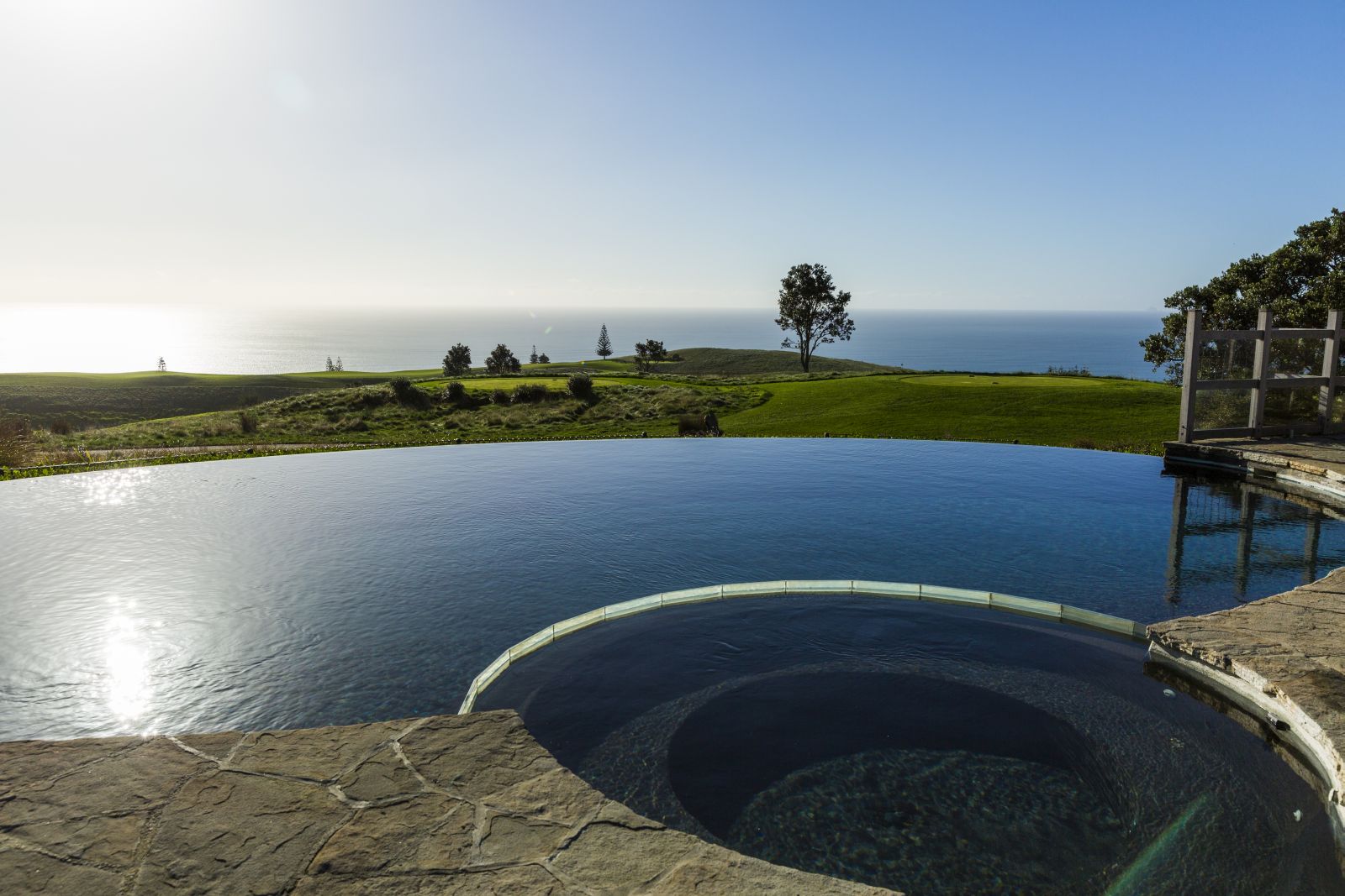 The infinity pool at Kauri Cliffs Lodge in New Zealand with the Pacific Ocean in the background
