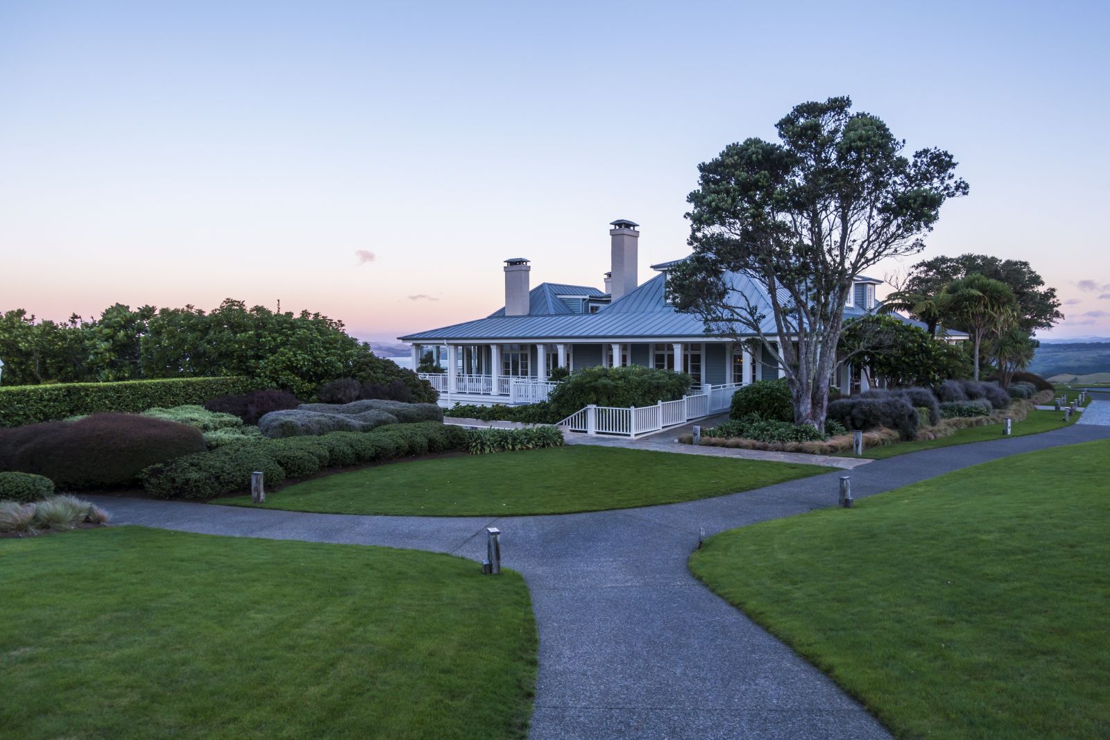 Exterior view of Kauri Cliffs at dusk