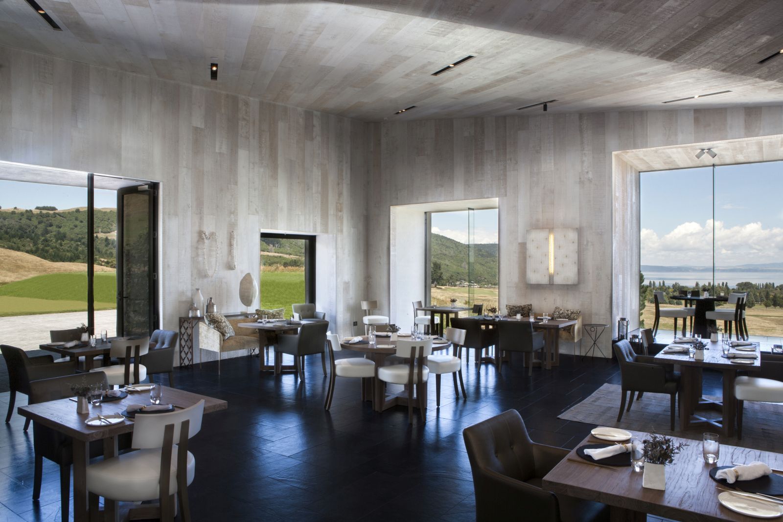 Kinloch Club New Zealand dining area with grey tones and views over the golf course