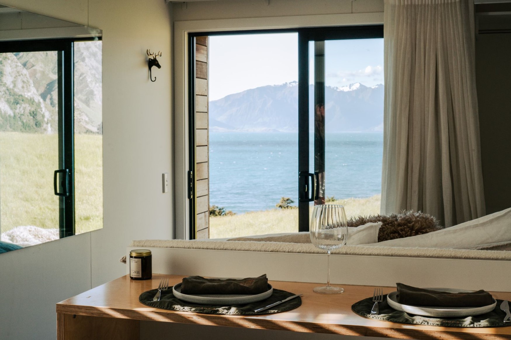 Dining area of a cottage with lake view at Lake Hawea Station, a luxury lodge in New Zealand