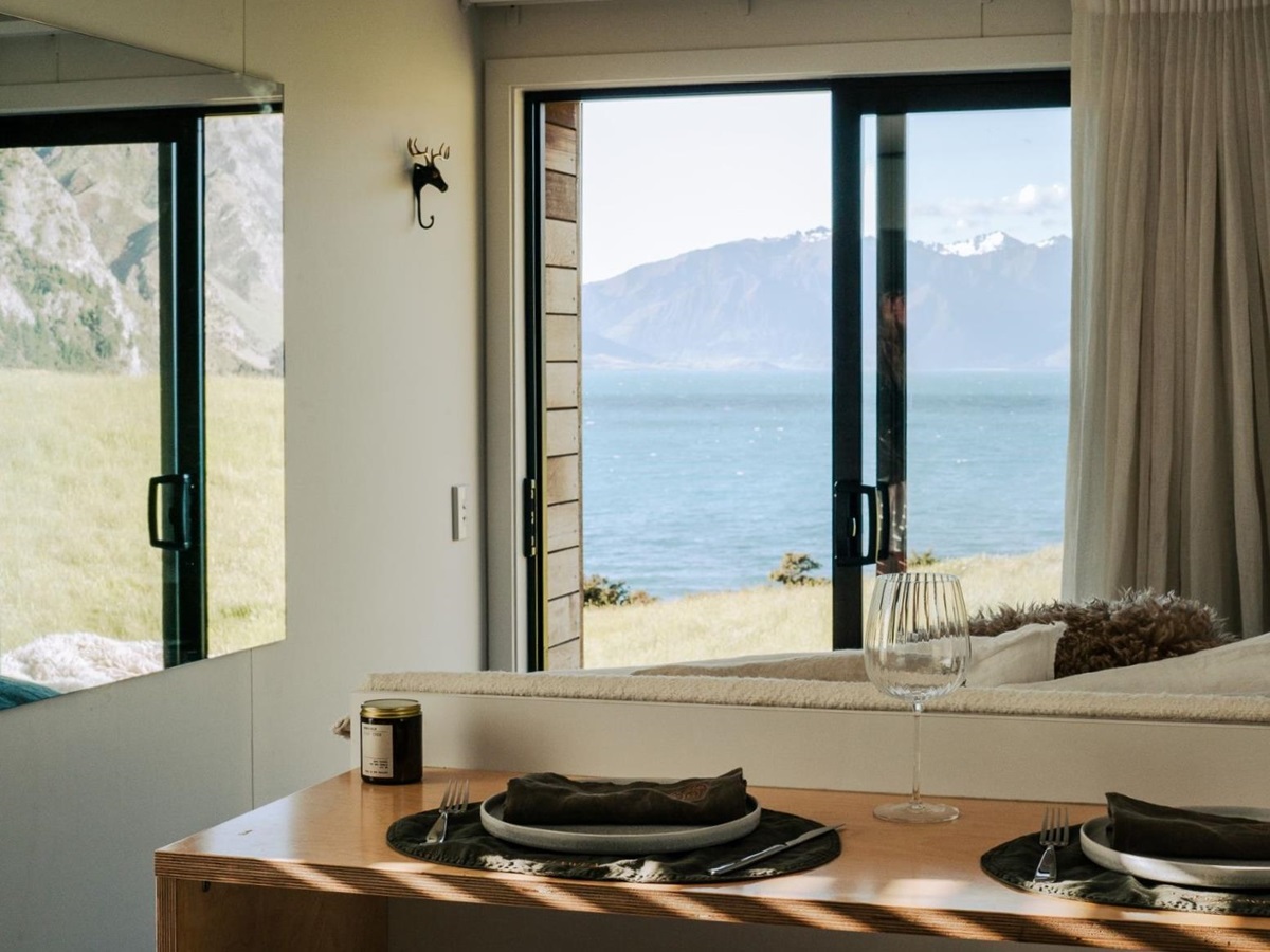 Dining area of a cottage with lake view at Lake Hawea Station, a luxury lodge in New Zealand