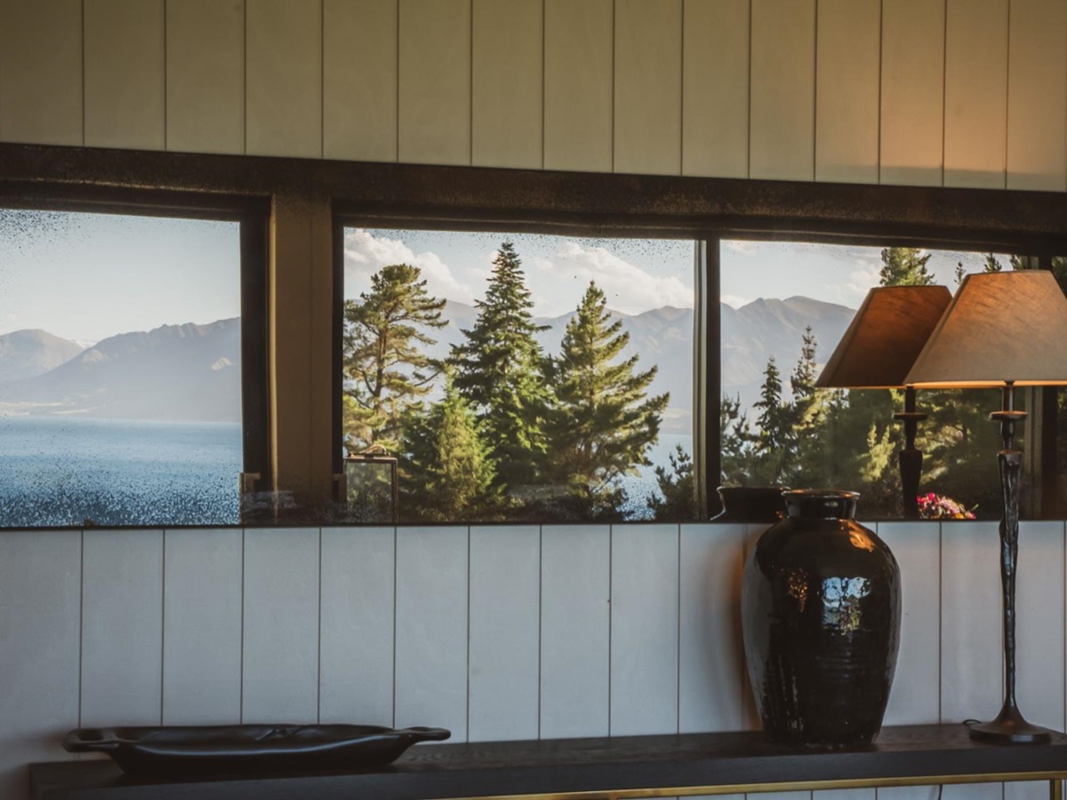 Lake and mountain view reflected in the mirror in a cottage at Lake Hawea Station, a luxury lodge in New Zealand