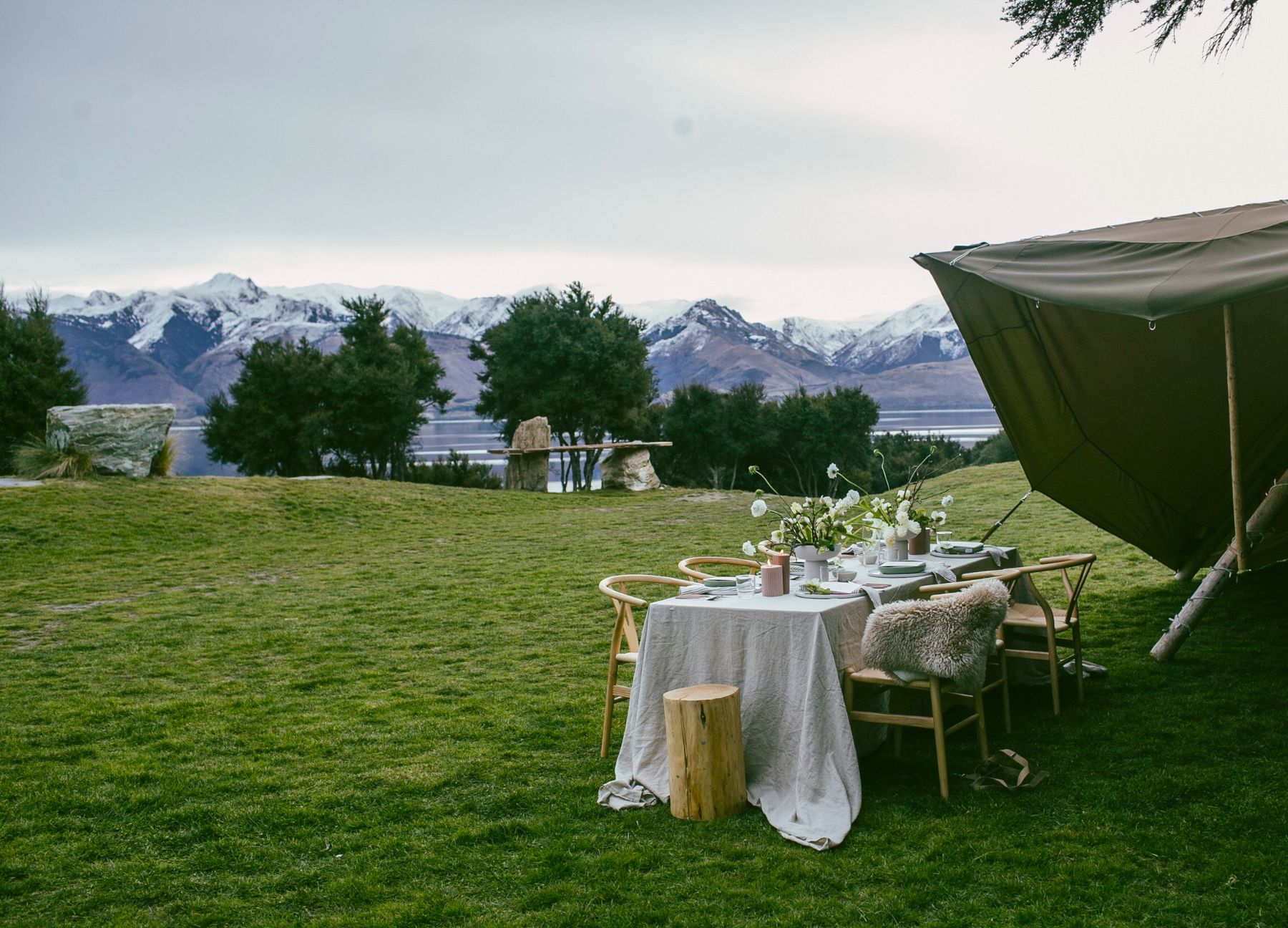 Table set up for outdoor private dining with mountain views at Lake Hawea Station, a luxury lodge in New Zealand
