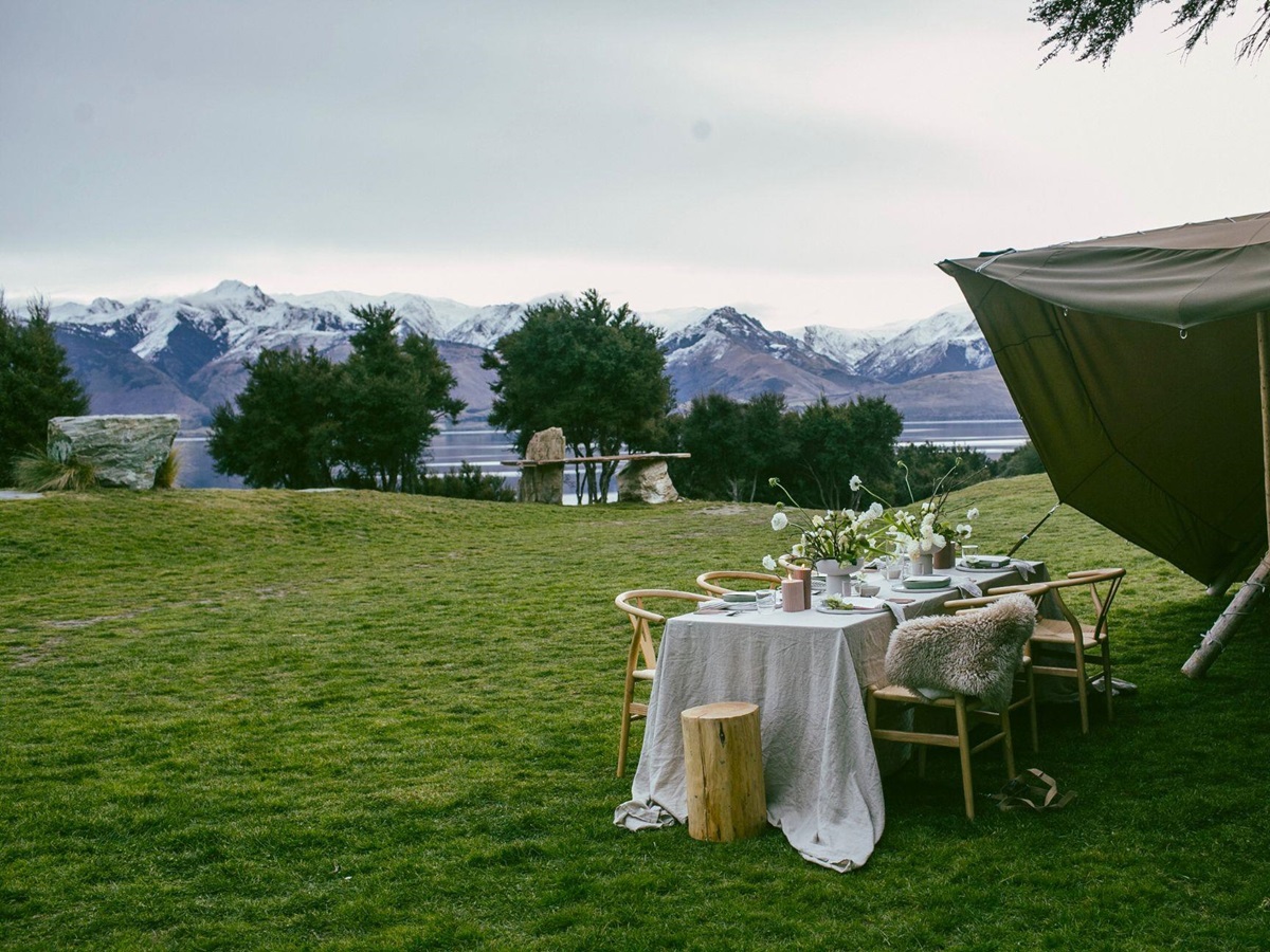 Table set up for outdoor private dining with mountain views at Lake Hawea Station, a luxury lodge in New Zealand