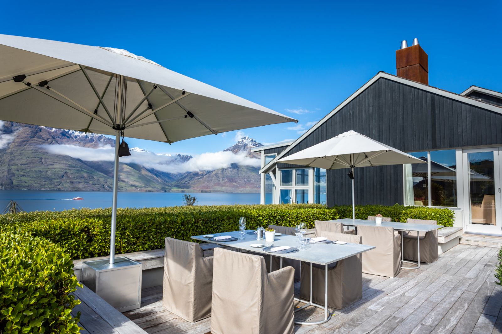 Outdoor dining area with sea view at Matakauri Lodge New Zealand