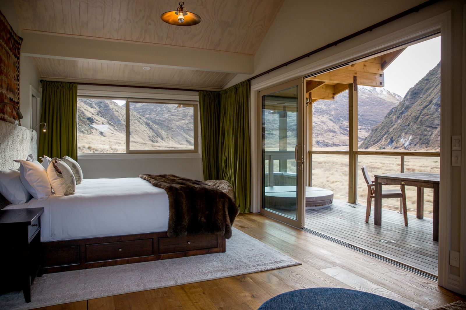 bedroom and deck in a guest chalet at Minaret Station on New Zealand's South Island