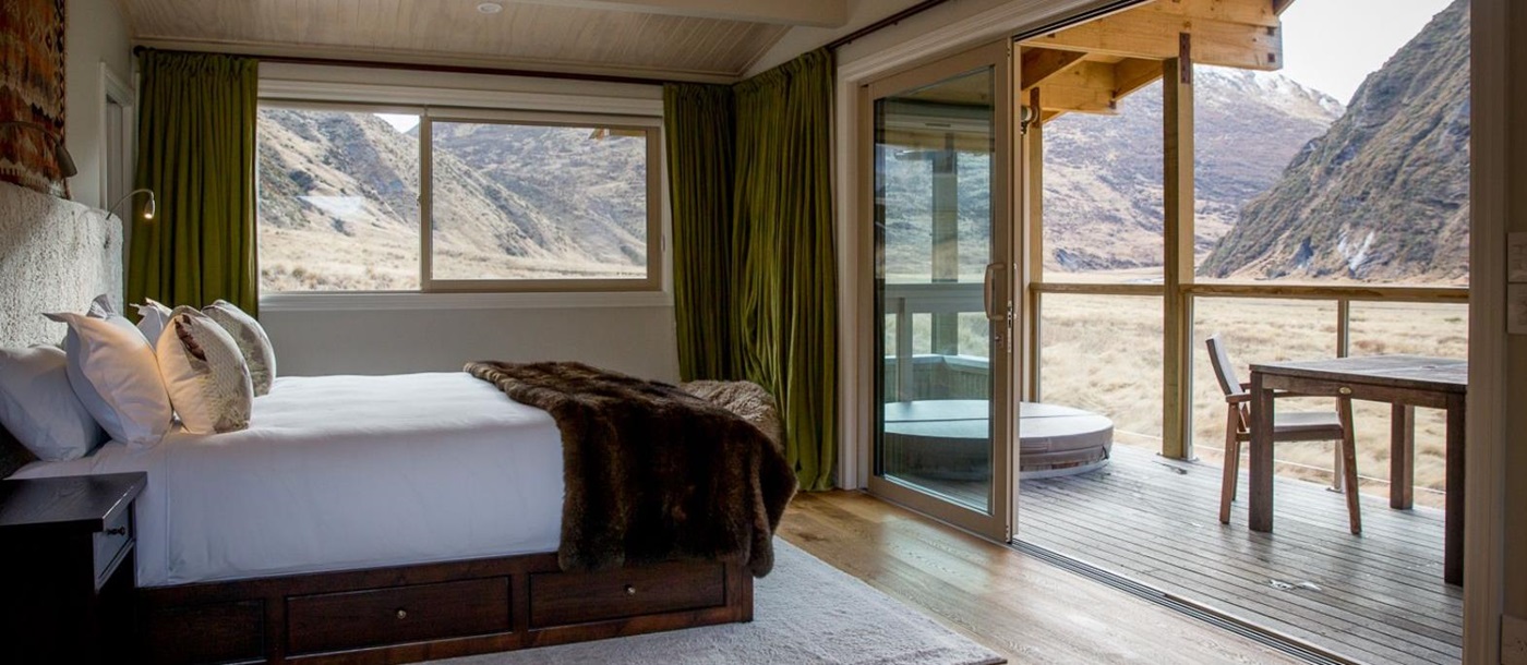 bedroom and deck in a guest chalet at Minaret Station on New Zealand's South Island