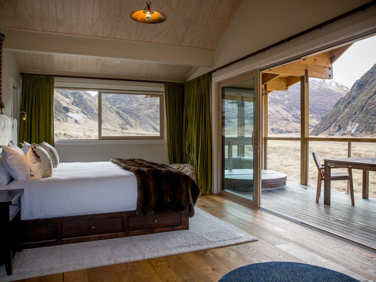 bedroom and deck in a guest chalet at Minaret Station on New Zealand's South Island