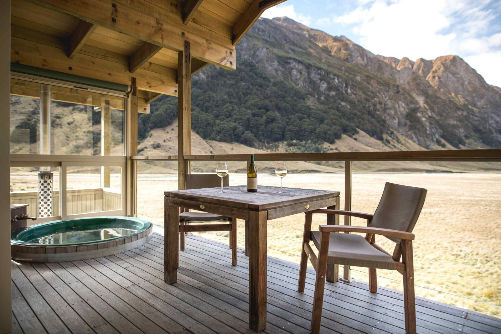 Chalet deck with hot tub and seating at Minaret Station on New Zealand's South Island