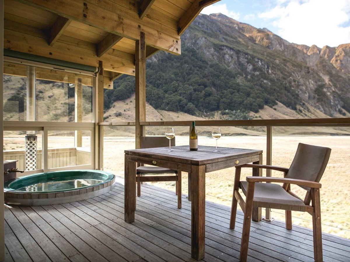 Chalet deck with hot tub and seating at Minaret Station on New Zealand's South Island