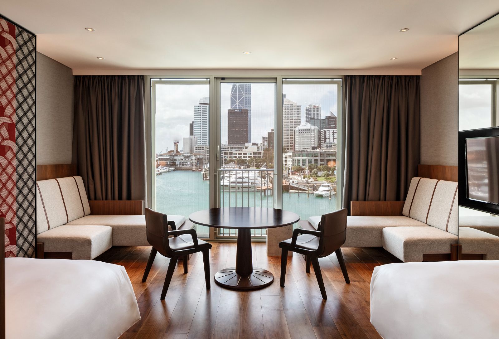 Guest bedroom lounge with city view at Park Hyatt Auckland in New Zealand