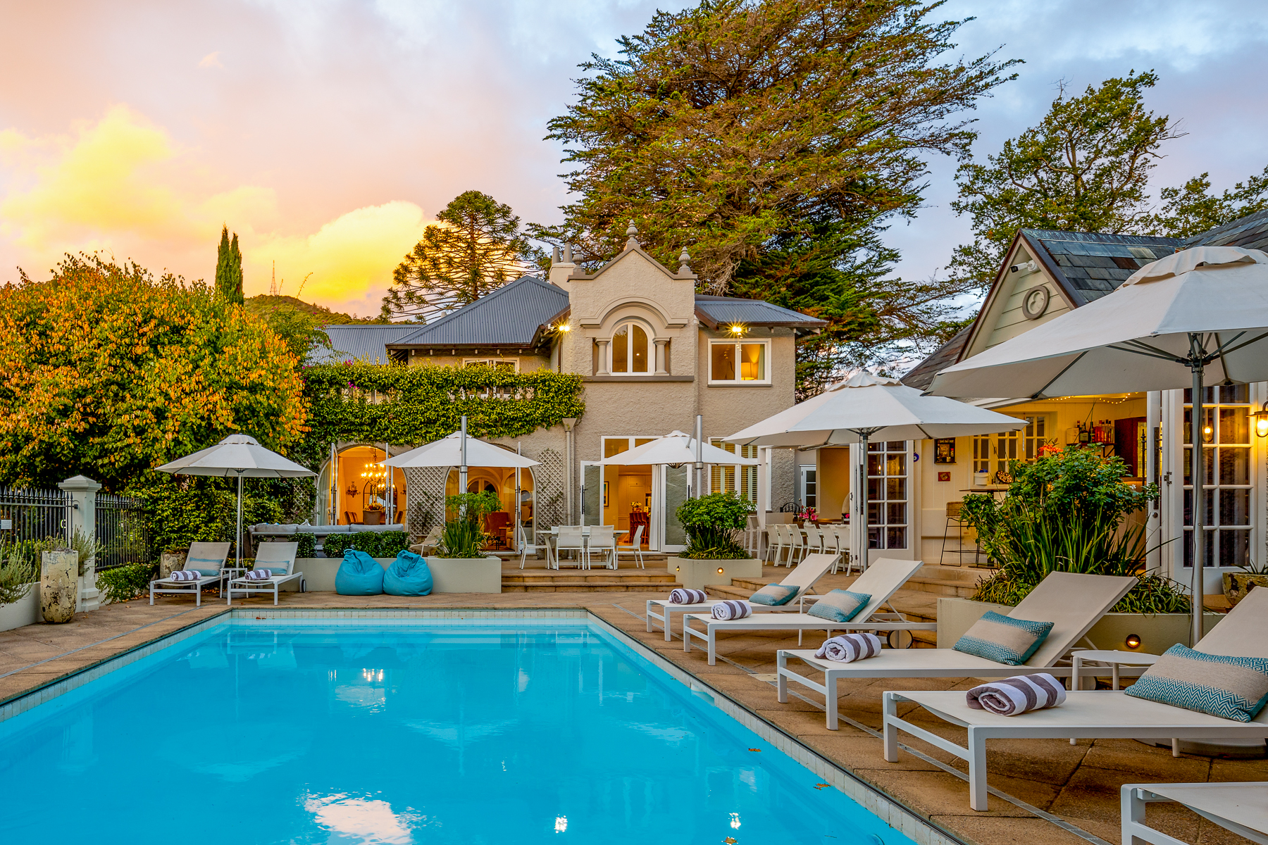 Sun loungers by the heated swimming pool at Pihopa Retreat in Nelson, New Zealand