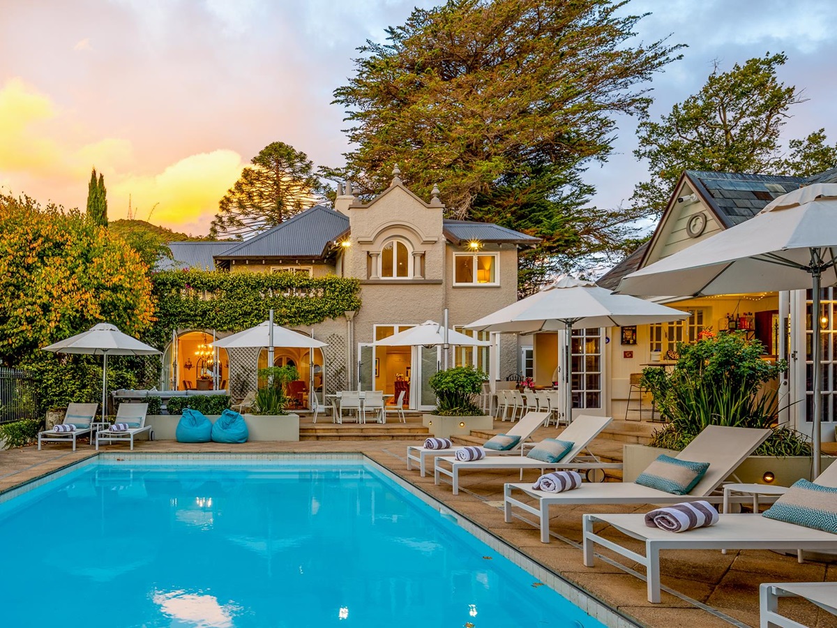 Sun loungers by the heated swimming pool at Pihopa Retreat in Nelson, New Zealand
