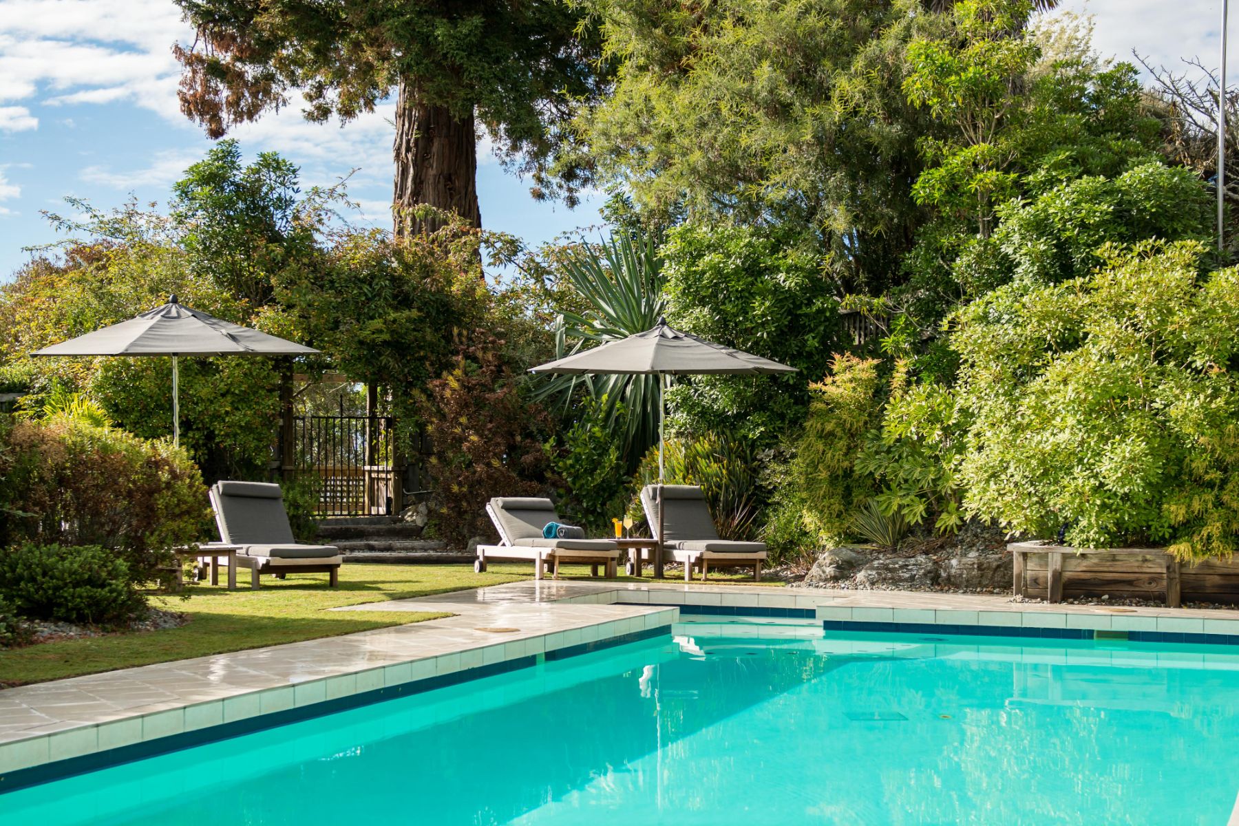 Swimming pool and gardens at Te Koi The Lodge in New Zealand