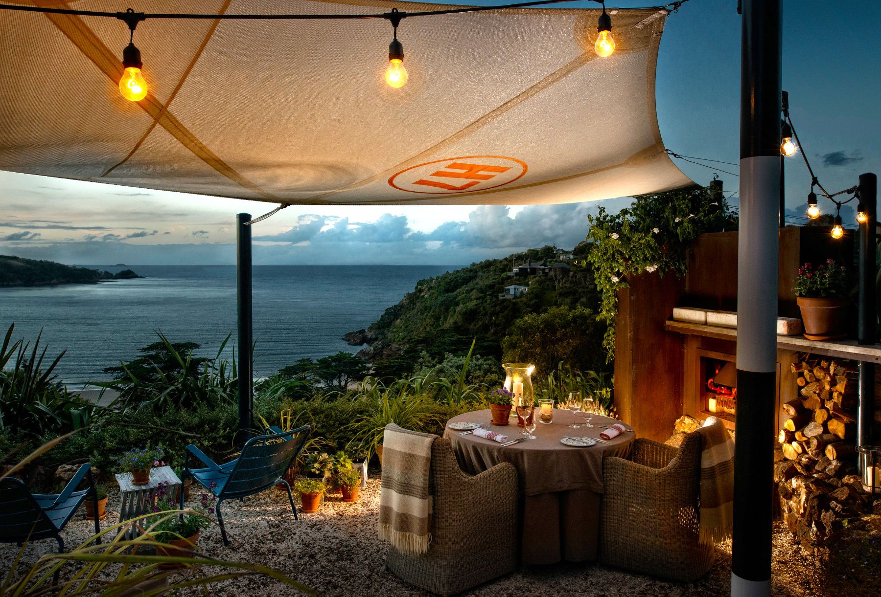 Table set for an outdoor dinner looking out to sea at The Boatshed on Waiheke Island New Zealand