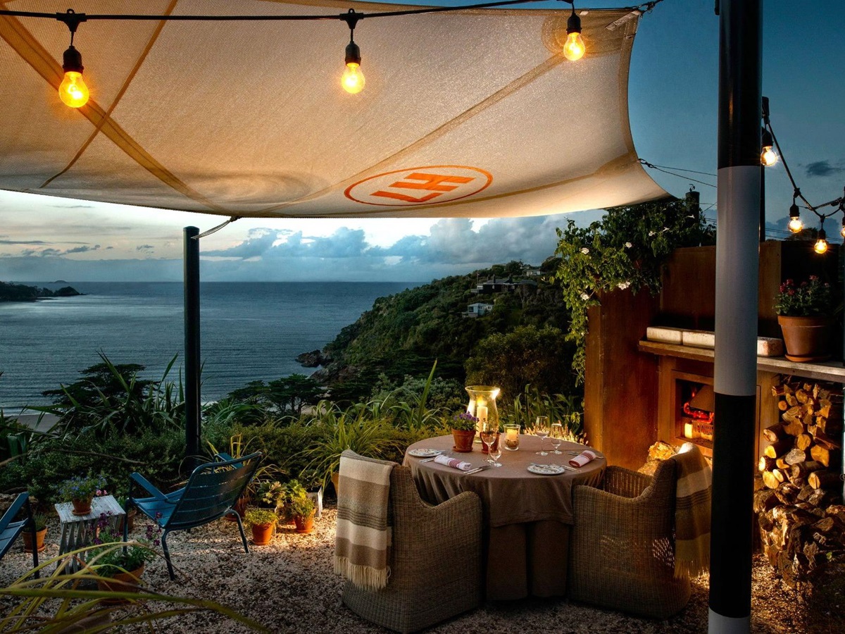 Table set for an outdoor dinner looking out to sea at The Boatshed on Waiheke Island New Zealand