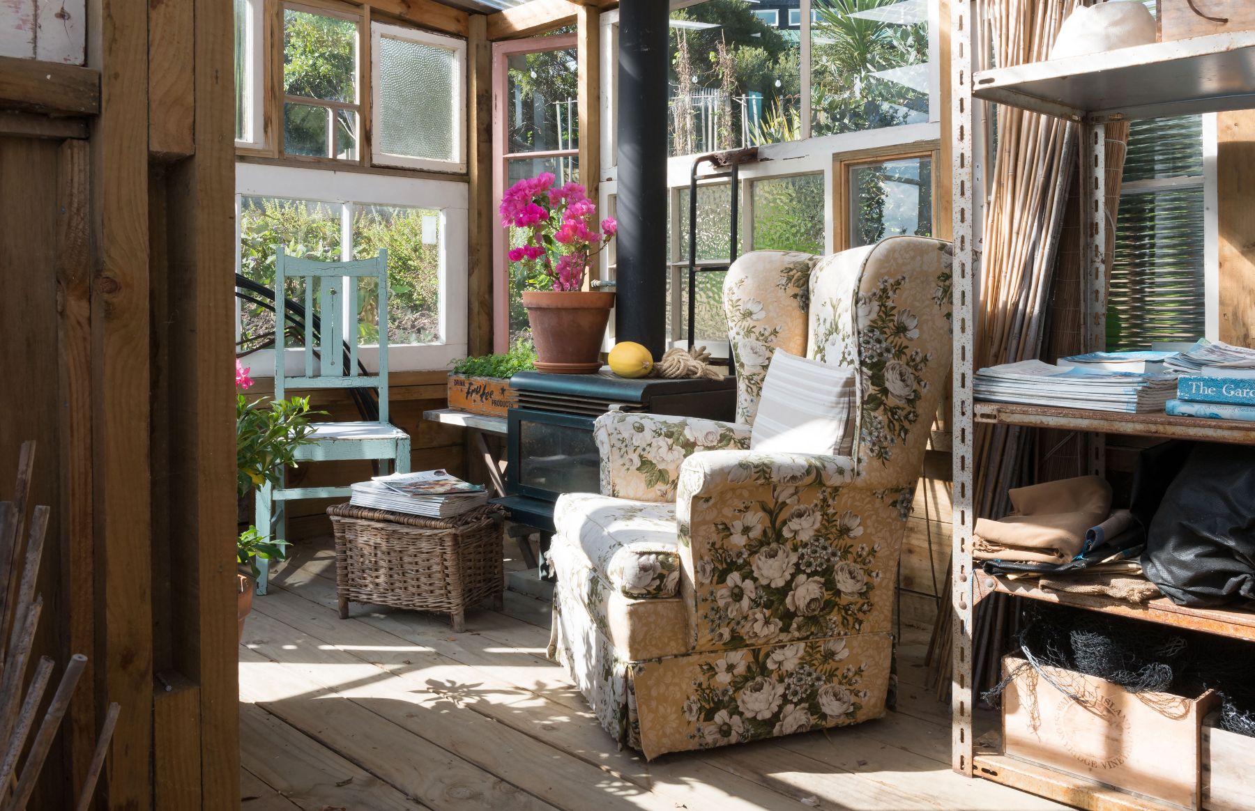 Arm chair and fireplace in the reading room at The Boatshed Waiheke Island New Zealand