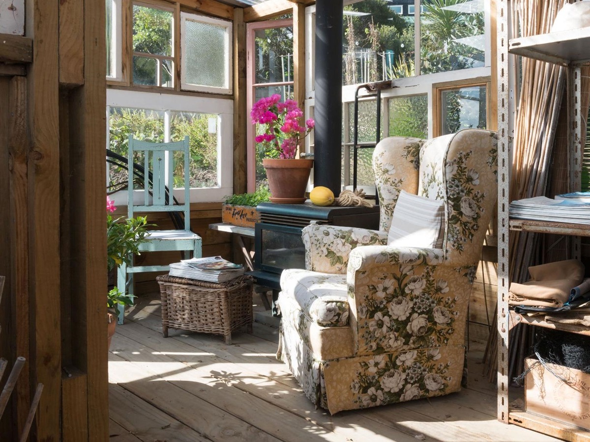 Arm chair and fireplace in the reading room at The Boatshed Waiheke Island New Zealand