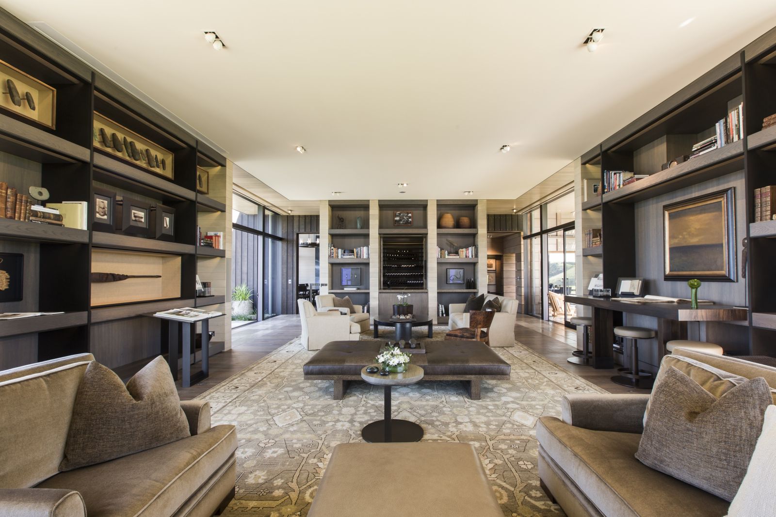 The Landing New Zealand Cooper Residence living area with bookshelves and sofas