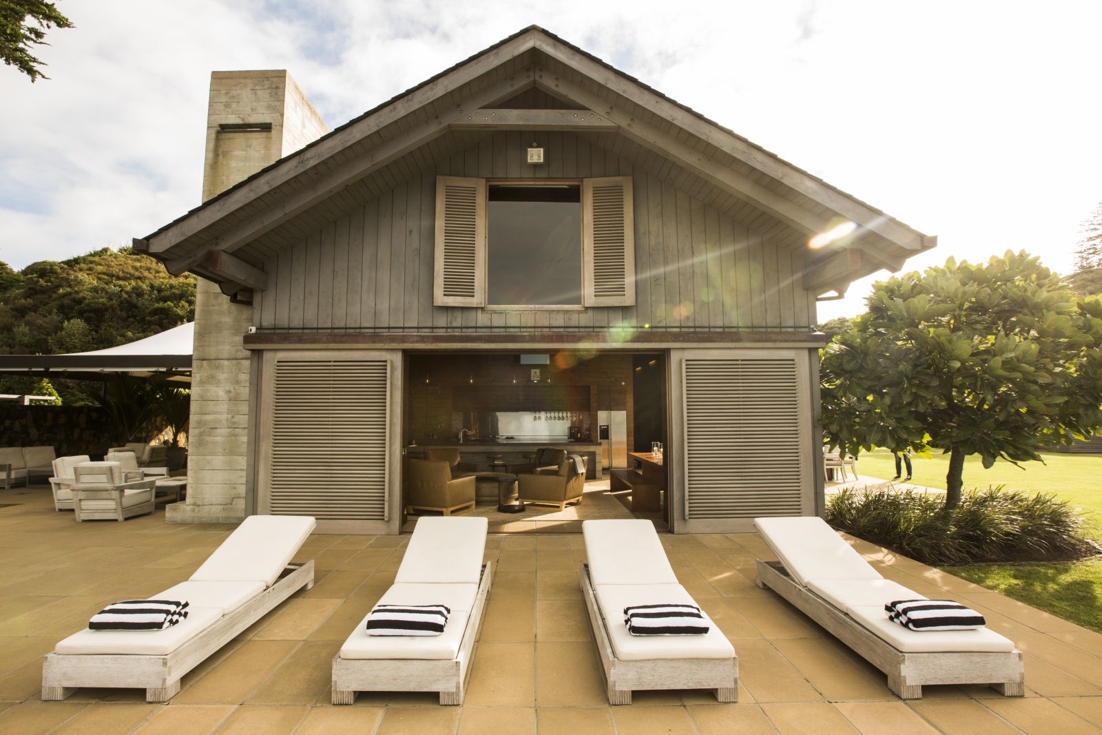 The Landing New Zealand The Boathouse loungers in front of the house
