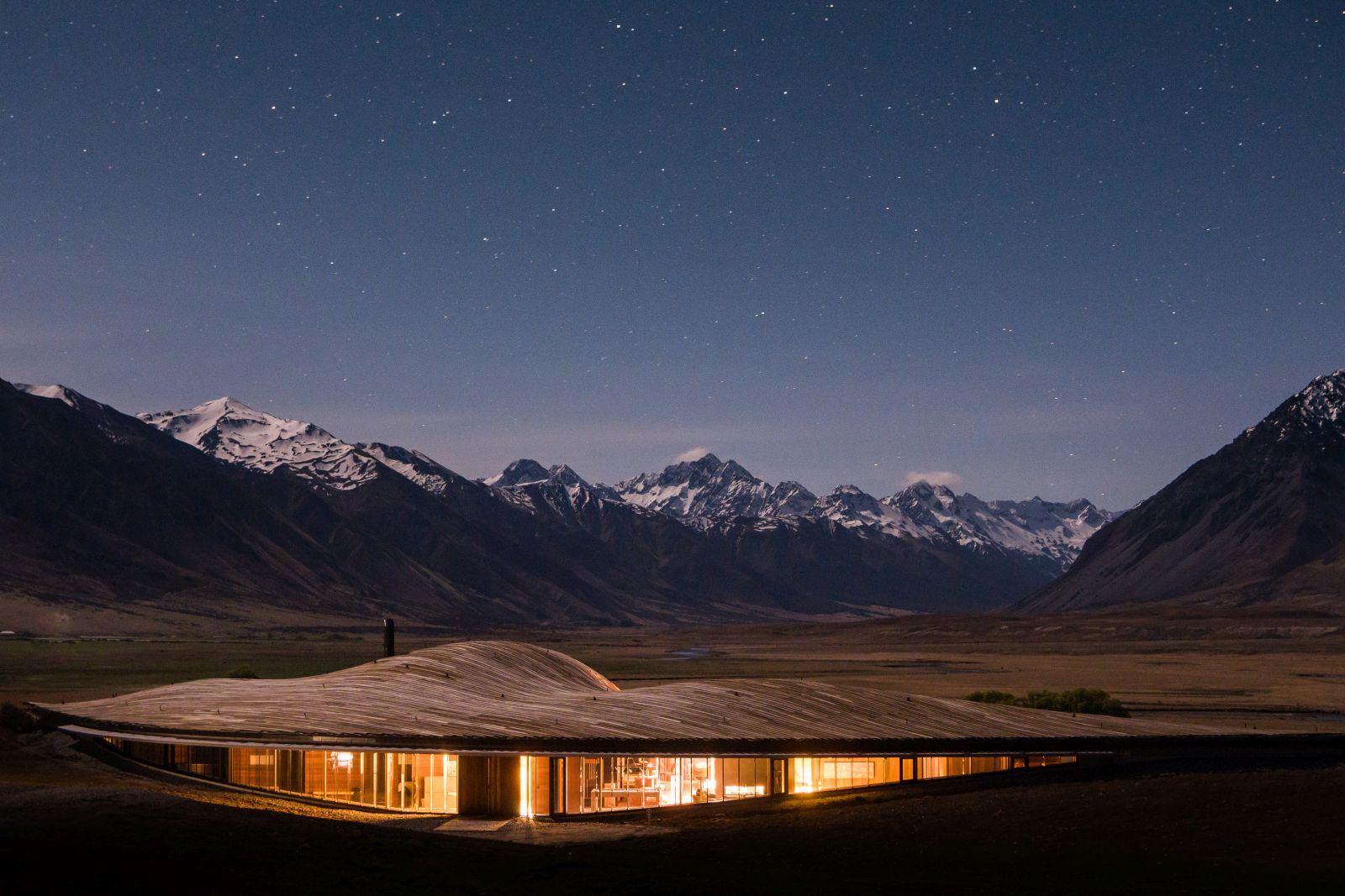 The exterior of The Lindis Lodge in New Zealand at sunset