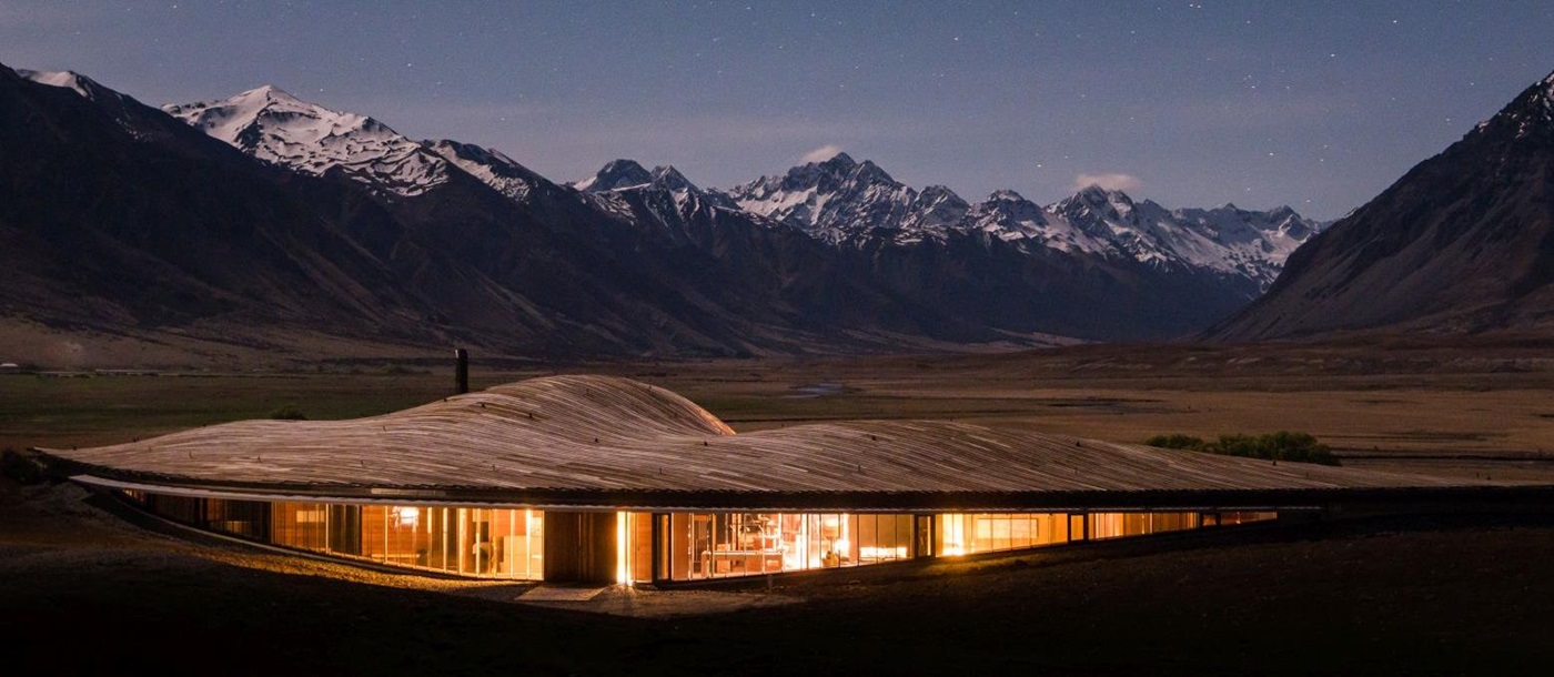 The exterior of The Lindis Lodge in New Zealand at sunset