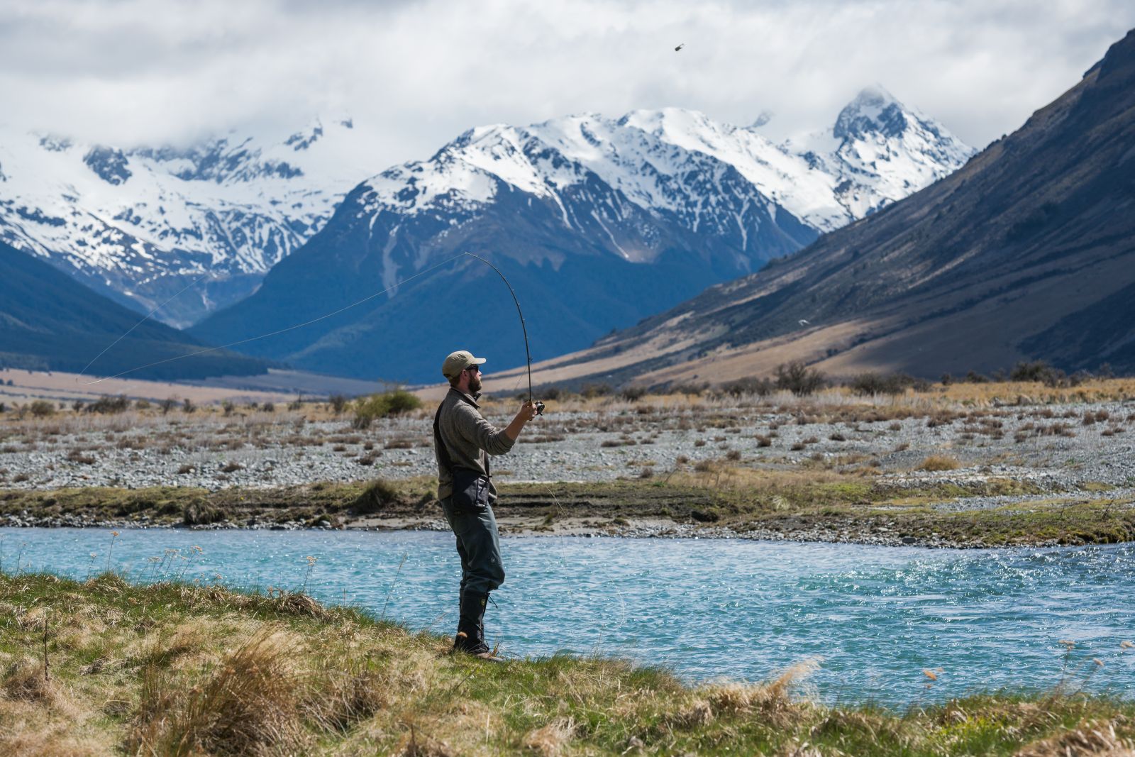 A man fly fishing on the edge of the Ahuriri River at The Lindis Lodge in New Zealand