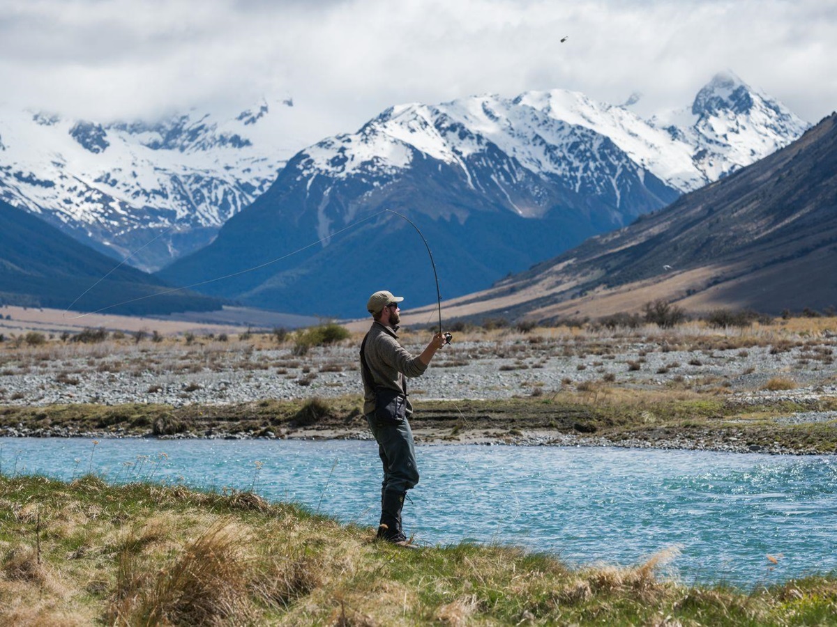 A man fly fishing on the edge of the Ahuriri River at The Lindis Lodge in New Zealand