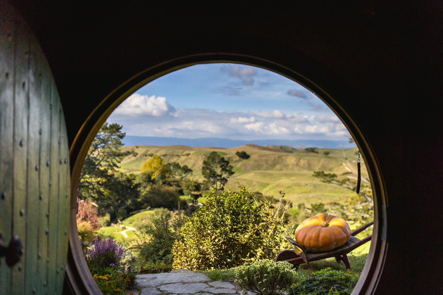 View across the landscape framed through a door at the Hobbiton film set