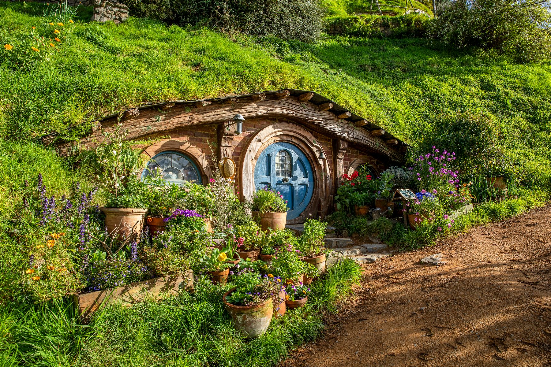 Exterior view of a hobbit house on the Hobbiton film set
