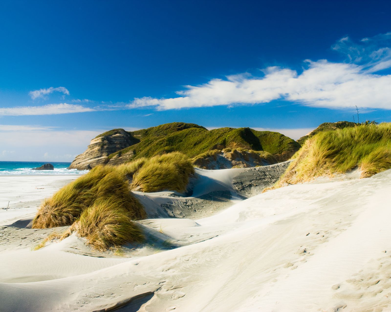 White sandy beach with sweeping dunes at the Bay of Islands, North Island
