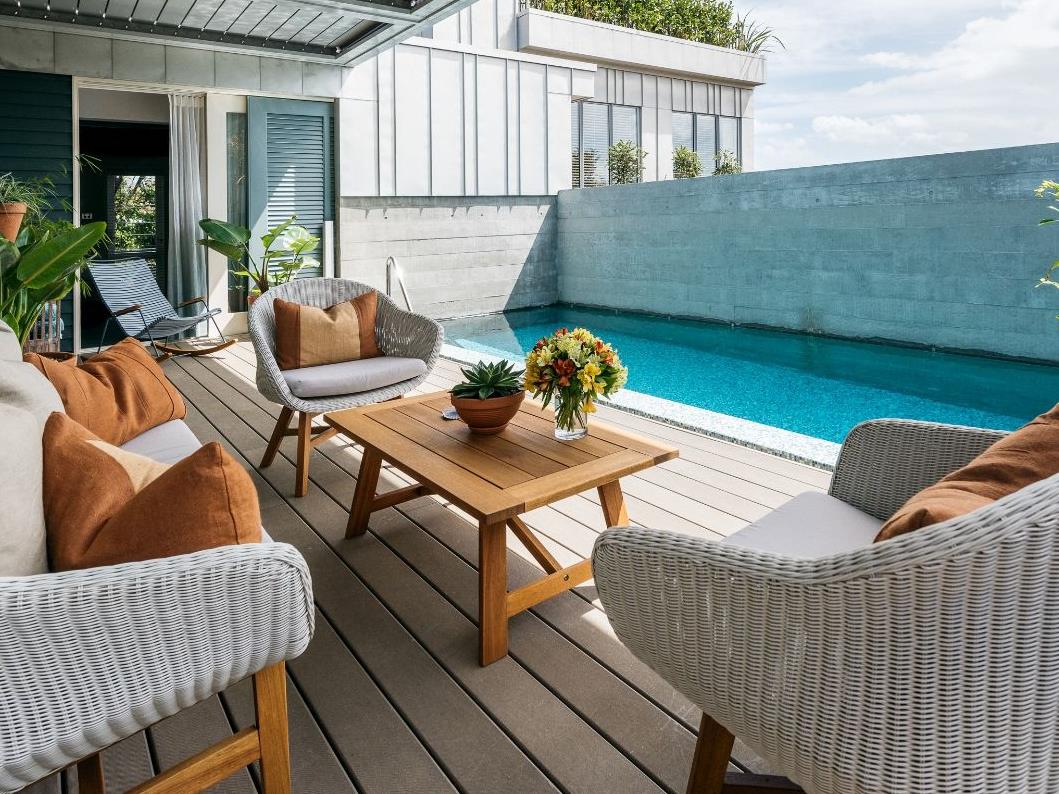 Outdoor dining area with outdoor pool at The Boatshed, Waiheke Island, New Zealand