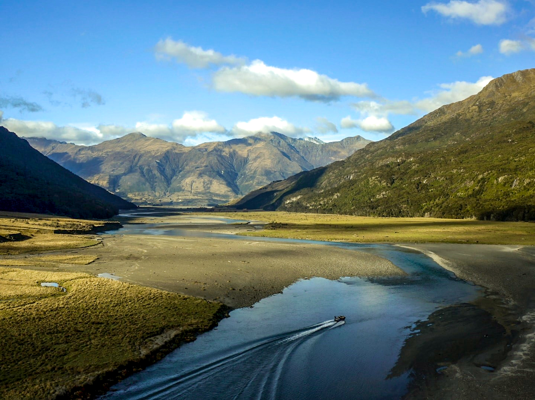 A boat cruising through Wilkin Header in New Zealand